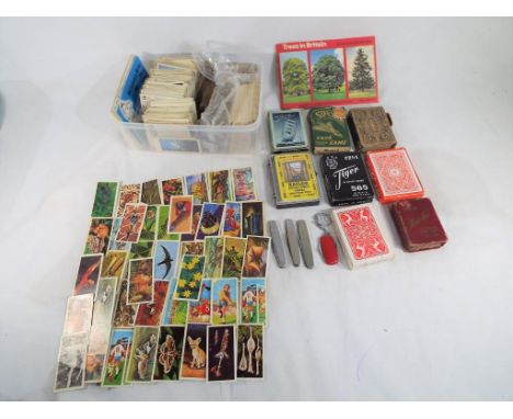 Approximately 1000 cigarette cards, Brooke Bond tea cards and PG Tips cards, 8 packs of vintage playing cards and 4 penknives