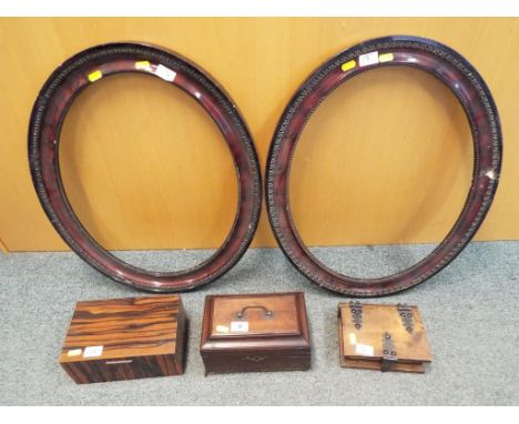 A mahogany veneered tea caddy and two further wooden boxes and two oval picture frames glass absent (5)