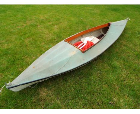 A vintage canoe 332 cm (length) x 82 cm (width) with two paddles and a life jacket