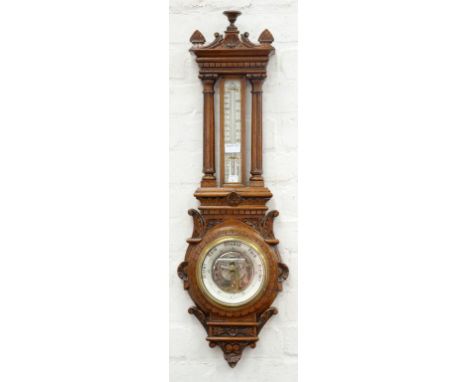 AN EDWARDIAN CARVED OAK ANEROID BAROMETER, WITH MERCURY THERMOMETER, 88CM H, C1910