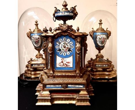 FRENCH GILDED CLOCK AND GARNITURES WITH ENAMEL PANELS DEPICTING CHERUBS, BIRDS AND FLORAL SPRAYS, GARNITURES UNDER GLASS DOME