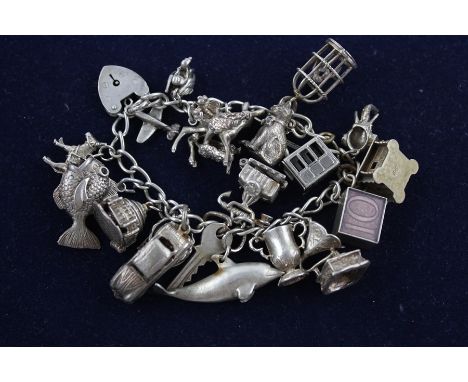 Vintage silver charm bracelet  with a mixture of charms (88g)
