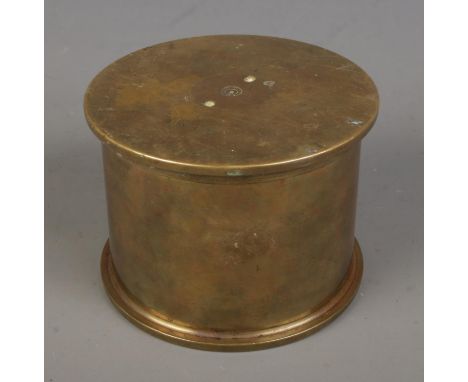 A WWI trench art shell jar and cover, composed of two 4.5 Howitzer cases dated 1916 and 1917. The base bares broad arrow mark