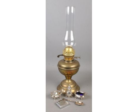 A brass oil lamp along with a collection of white metal items. Includes Mosda Streamline 500 lighter, Mappin &amp; Webb souve