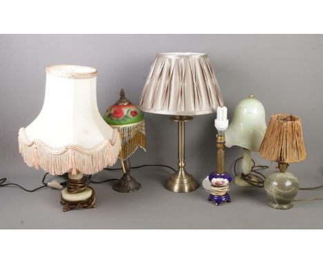 A collection of small table lamps to include hardstone, and ceramic examples.  