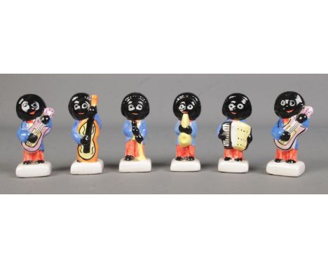 Six Carlton Ware ceramic Golly musicians to include guitarist, singer, saxophonist, cellist and accordian player. These items