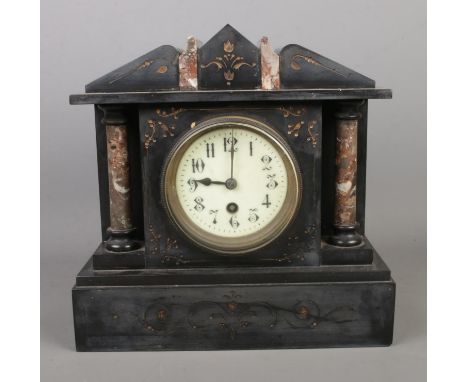 A slate and marble mantle clock featuring column decoration.  