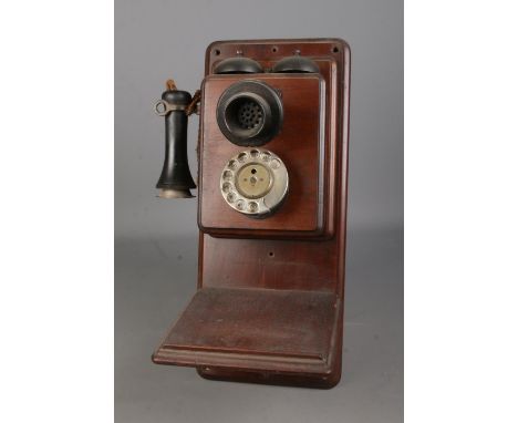 An early 20th century wall mounted stick phone and bell box.  