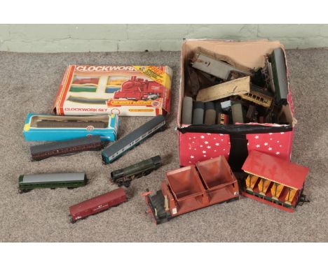 A box of assorted OO gauge model railway locomotives and carriages to include Hornby, Airfix, boxed Hornby Clockwork Set, etc