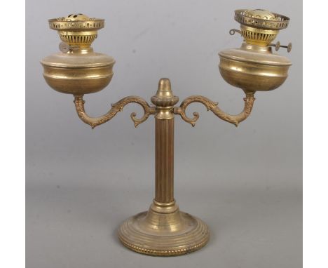 A late 19th/early 20th century brass twin light oil lamp.  