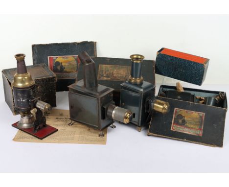 Four boxed Magic Lanterns, German 1900/10, including a Carette tinplate lantern on gold painted feet, with burner, chimney, l