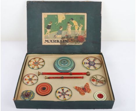 Marklin boxed set of tinplate spinning tops, 1920s, the set with ten hand painted and tin printed spinning tops including a f
