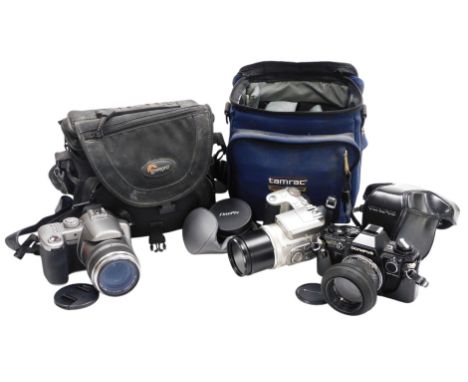 An Olympus OM10 camera, a Panasonic Lumix camera DMCFZ750, and a Fuji film, 6X Optical Zoom camera.