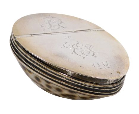 An early 19thC cowrie shell snuff box, with white metal mount and hinged lid, presentation engraved and dated 1814. 