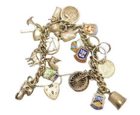 A curb link charm bracelet, on a heart shaped padlock clasp, with safety chain, and various charms, as fitted, silver and whi