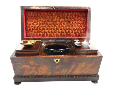 A Regency mahogany tea caddy of sarcophagus form, with a hinged lid opening to reveal two lidded compartments flanking a rece