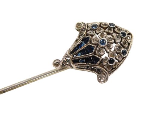 An Art Deco white and blue paste tie pin, in a stylised basket of flowers design, in white metal, stamped 900, 4.5g.