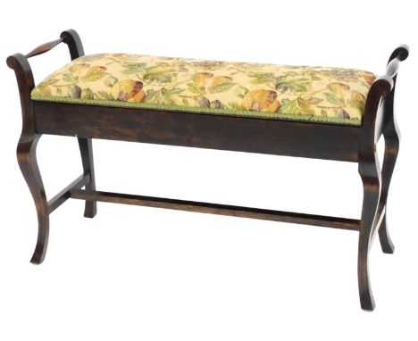 An Edwardian stained beech duet piano stool, with a hinged padded seat, on cabriole legs, 102cm wide. 