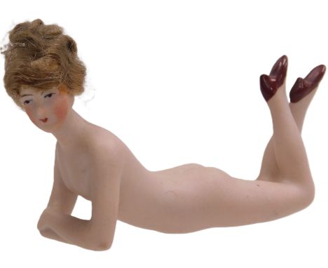 A German Art Deco bisque porcelain figure of a nude lady, manner of Gallup &amp; Hoffman, in a relining pose, with her legs r