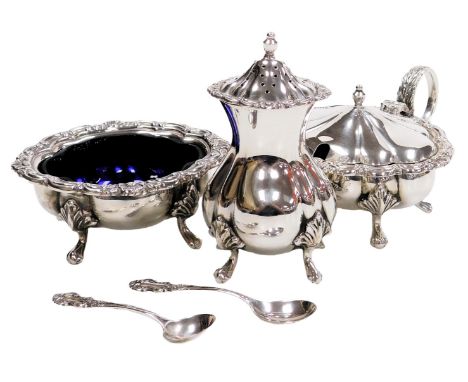 An Elizabeth II silver three piece condiment set, with spoons and blue glass liners, of fluted form, the rims embossed with s