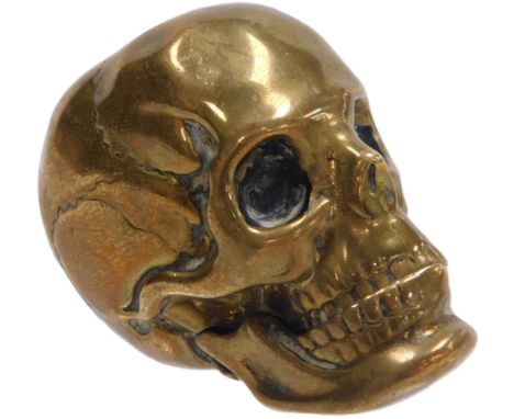A Victorian brass vesta case, naturalistically cast as a human skull, with a hinged jaw.