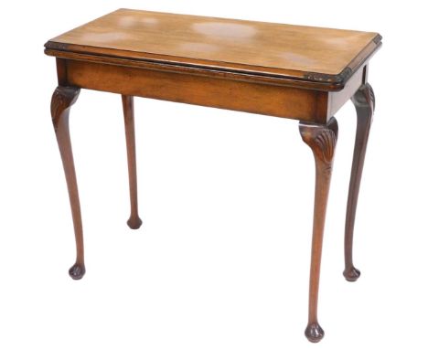 A walnut card table, the rectangular hinged top with a moulded edge, on shell carved cabriole legs and pad feet, 77cm high, 8