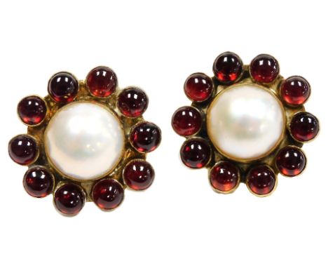 A pair of blister pearl and cabochon garnet cufflinks, of flowerhead form, in yellow metal.
