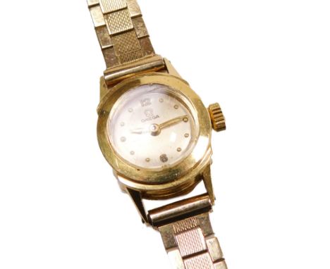 An Omega lady's 9ct gold cased wristwatch, circular champagne dial with gold dot markers, the case of plain form, on a bracel