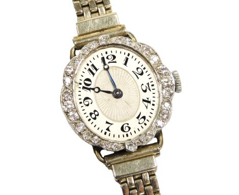 A mid Century lady's diamond cocktail watch, the oval silvered dial with engine turned decoration, chapter ring bearing Arabi