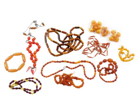 Assorted amber and simulated amber bead necklaces, polished and rough hewn, together with loose beads.