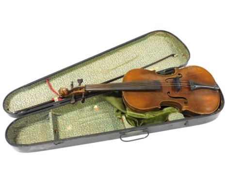 A 19thC German violin, with a two piece back and lion's head carved scroll, bears spurious Stradivarius label, together with 