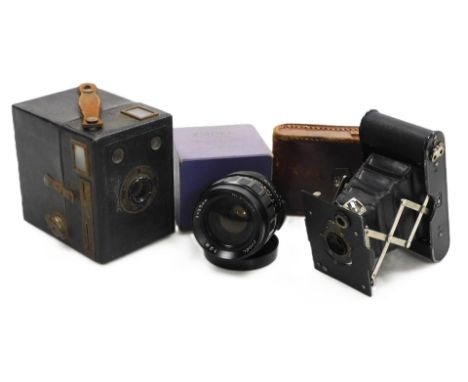 An Eastman West Pocket Kodak camera, cased, Kodak Popular Brownie camera, and a Zodel 1:2.8f 35mm lens.