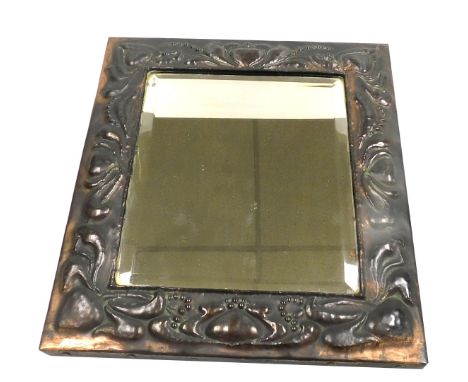 A late 19thC Art Nouveau copper framed wall mirror, the rectangular bevelled plate embossed with stylised floral and foliate 