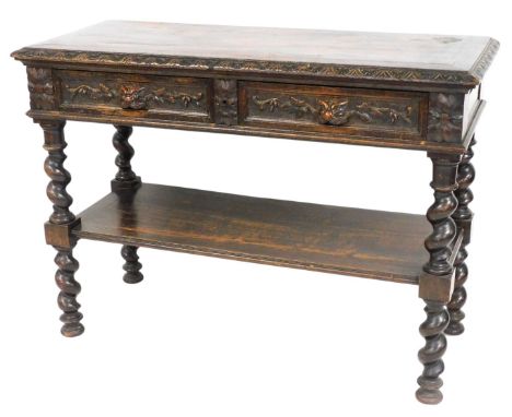 A Victorian dark stained oak buffet, the rectangular top with a carved border above two drawers with mask handles, flanked by