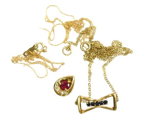 A ruby and diamond pendant, in a teardrop setting, yellow metal stamped 14k, on a fine neckchain, 1.4g, together with a 9ct g