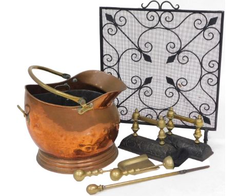 A Victorian copper helmet coal bucket, pair of Victorian brass and cast iron andirons, brass poker, brush and shovel, and a c