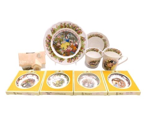 An Aynsley porcelain Snow White and The Seven Dwarfs plate, cottage money box, mug, teacup and saucer, and four Royal Doulton