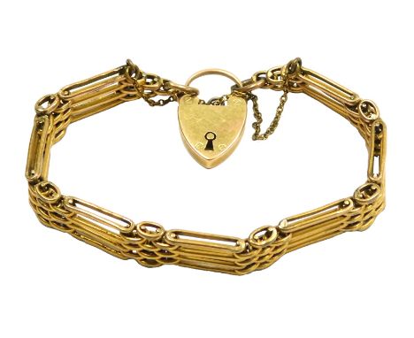 A four bar gate bracelet, on a heart shaped padlock clasp, with safety chain as fitted, clasp stamped 15c, 22.9g all in.