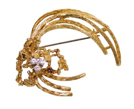 An 18ct gold and diamond three stone brooch, in an abstract tied spray form, 10.0g.
