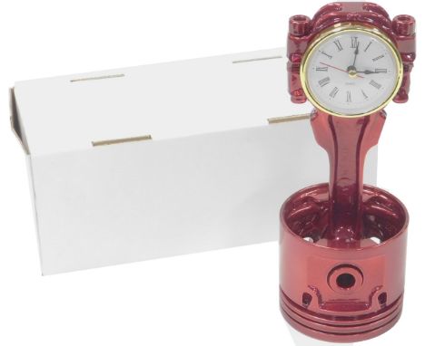 A Classic Rover upcycled V8 piston clock, in candy apple red powder coating, with quartz movement, boxed, 23cm high.