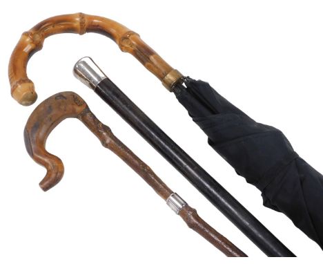 An early 20thC silver topped ebonised walking cane, London 1919, 72cm high, rootwood cane with silver ferule, Glasgow 1902, 9