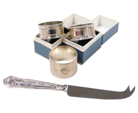 A George VI silver napkin ring, with engine turned decoration, circular reserve monogram engraved, London 1945, 1.5oz, pair o