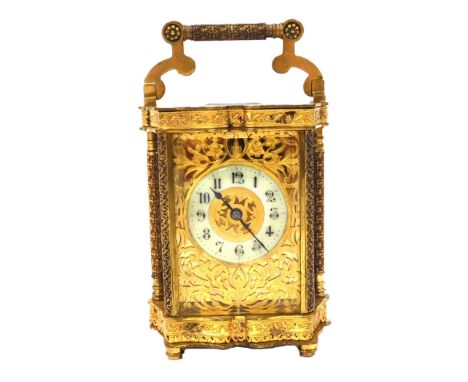 A late 19thC brass cased carriage clock, rectangular brass dial with floral engraved and foliate fretwork, circular enamel di