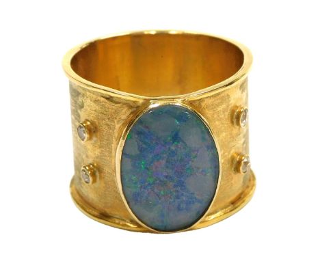 A gentleman's opal ring, the oval cut stone flanked by pairs of diamonds, in burnished yellow metal, size Z+3, 10.7g.