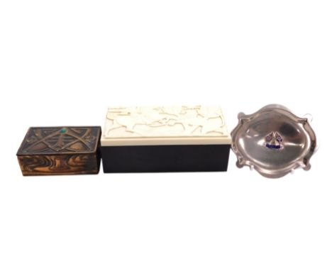 An Art Deco ELO ware black and white bakelite box, decorated to the lid with a knight slaying a lion, the hinged lid opening 
