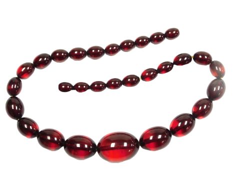 A partial string of graduated cherry amber beads, with thirty beads, 36.2g.