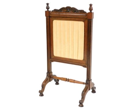 A Victorian rosewood fire screen, with a shell and scroll carved frieze flanked by finials, the sliding pleated adjustable ba
