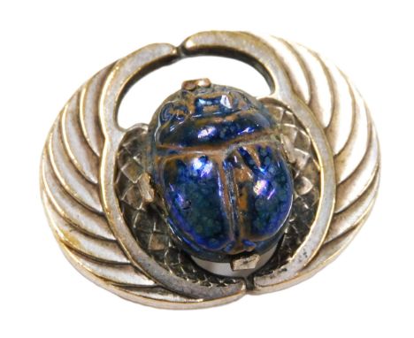 A 1920s Egyptian revival scarab brooch, with a Ruskin type iridescent scarab amulet, mounted on wings.
