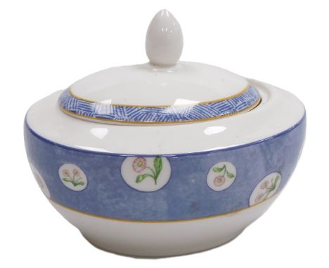 A Royal Doulton porcelain prototype sucrier and cover, decorated with reserves of flowers against a powder blue ground, print