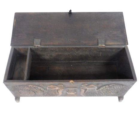 A small oak coffer, the rectangular top with carved ends above a frieze carved with dragons flanking a garden urn, on end sup
